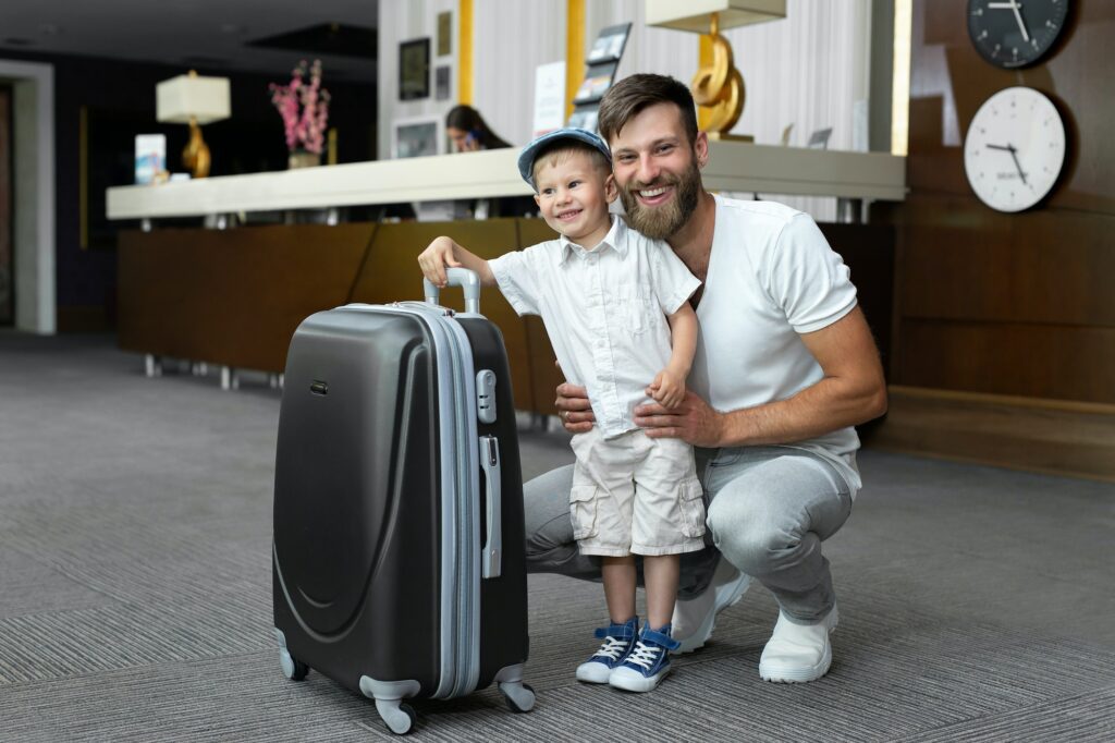 Father and son with a suitcase at the off site buffalo airport parking hotel reception