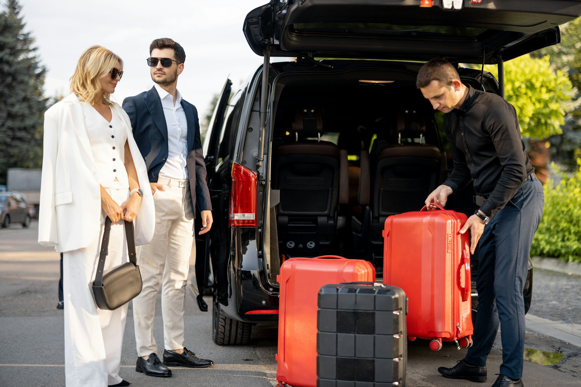 Business couple near minivan Buffalo Niagara Airport taxi with a suitcases and chauffeur
