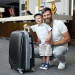 Father and son with a suitcase at the off site buffalo airport parking hotel reception